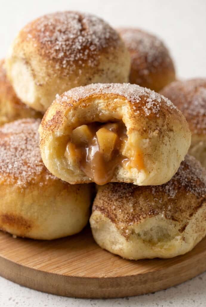 Caramel apple pie bomb cut open to show the warm apple and gooey caramel filling.