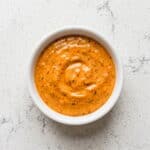 Creamy homemade chipotle garlic sour cream sauce in a bowl, ideal for tacos, sandwiches, and dipping.