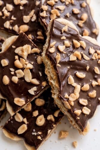Chocolate banana bark topped with melted dark chocolate and chopped peanuts, ready to serve as an easy dessert.
