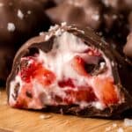 Chocolate-covered strawberry yogurt bite with creamy frozen strawberry center.