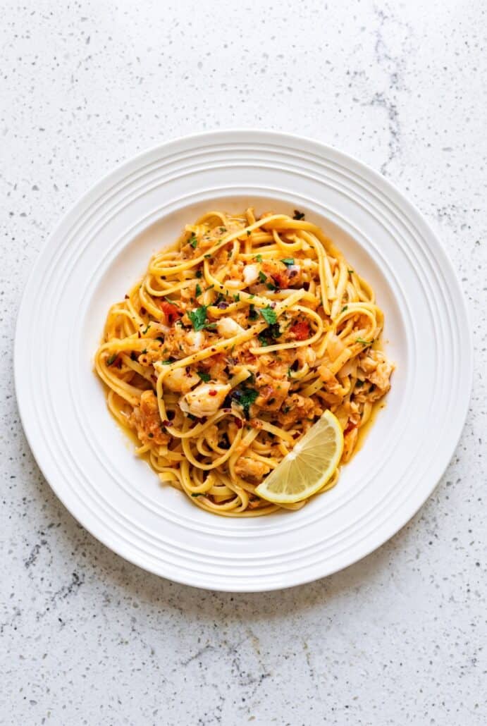 Crab linguine with fresh parsley and lemon, ready to serve as an easy seafood pasta dinner.
