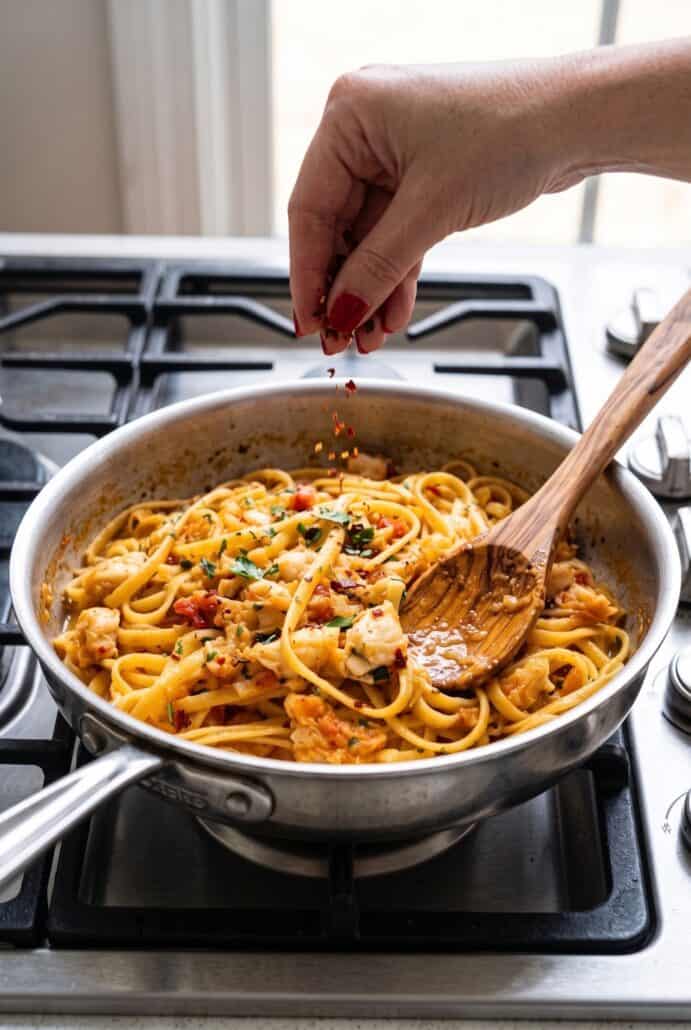 Crab linguine tossed in a skillet with parsley and red pepper flakes for an easy seafood pasta dinner.