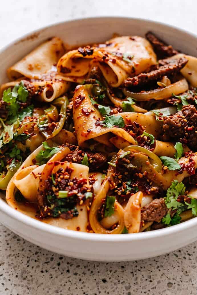 Cumin lamb noodles with tender sliced lamb, wide noodles, onions, greens, and bold toasted spices.