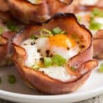 Ham and cheese egg cup with baked egg, melted cheese, and seasoned ham.