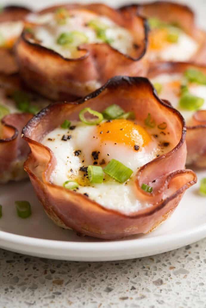 Ham and cheese egg cup with baked egg, melted cheese, and seasoned ham.