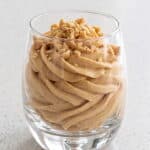 Creamy peanut butter mousse topped with chopped peanuts, ready to serve.