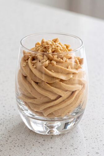 Creamy Peanut Butter Mousse Recipe Creamy peanut butter mousse topped with chopped peanuts, ready to serve.