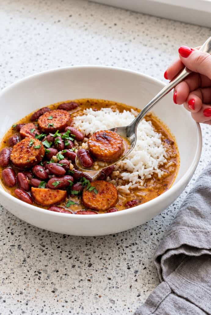 Red beans and Andouille sausage served with white rice, ready to enjoy as a hearty Southern-style meal.