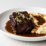 Red wine braised short rib in rich sauce for Dutch oven short ribs recipe.
