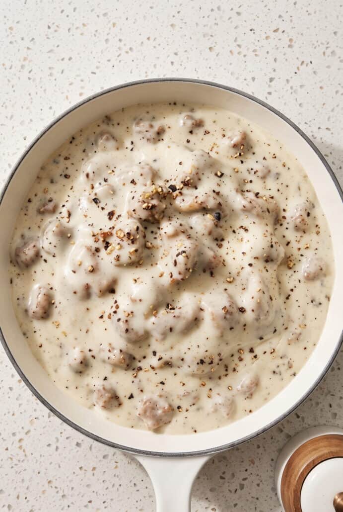 Creamy homemade sausage gravy with black pepper, ready to spoon over warm biscuits.