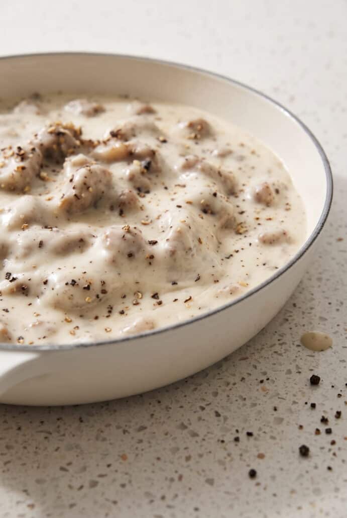 Creamy sausage gravy with savory sausage pieces and black pepper, perfect for serving over biscuits.