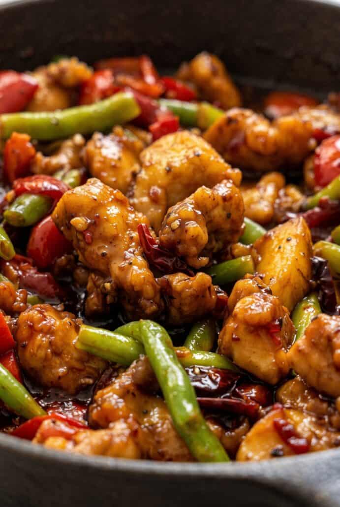 Crispy sweet chili chicken with green beans and red bell peppers coated in sticky sauce.