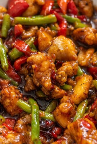 Crispy Sweet Chili Chicken and Green Bean Stir Fry Sweet chili chicken and green bean stir fry with bell peppers in a sticky sauce.