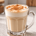 Hot vanilla cinnamon milk tea topped with cinnamon, ready to serve.