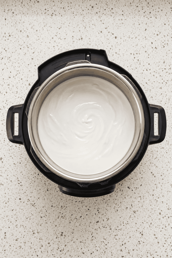 Creamy homemade Instant Pot yogurt in the inner pot, ready to chill and serve.